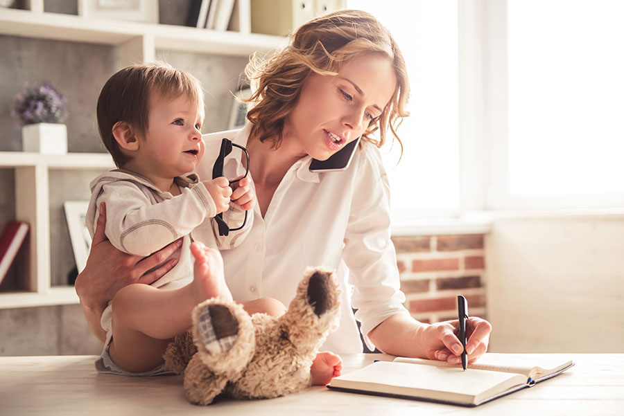 Busy-woman-talking-on-phone-holding-baby