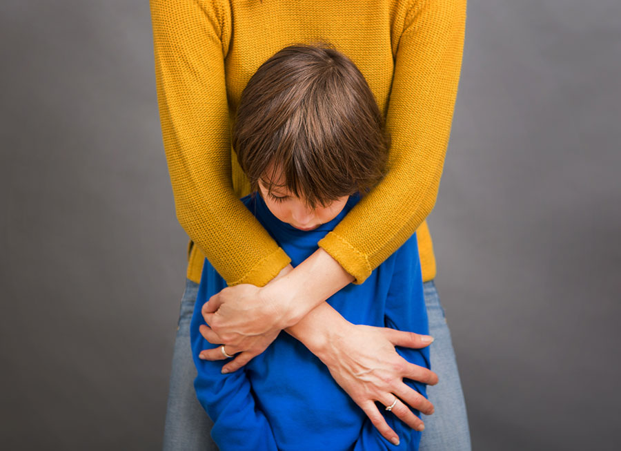 mother-hugging-upset-son