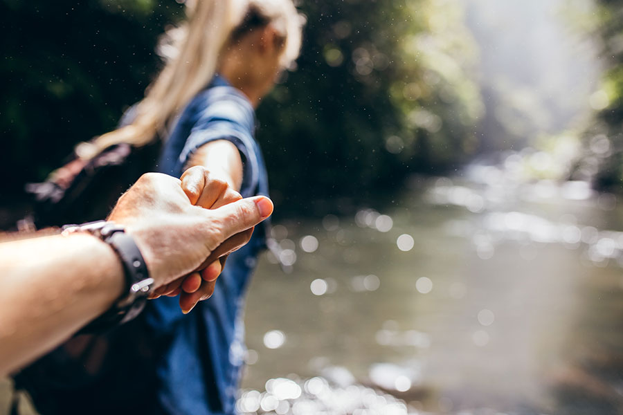 woman-leading-man-hiking