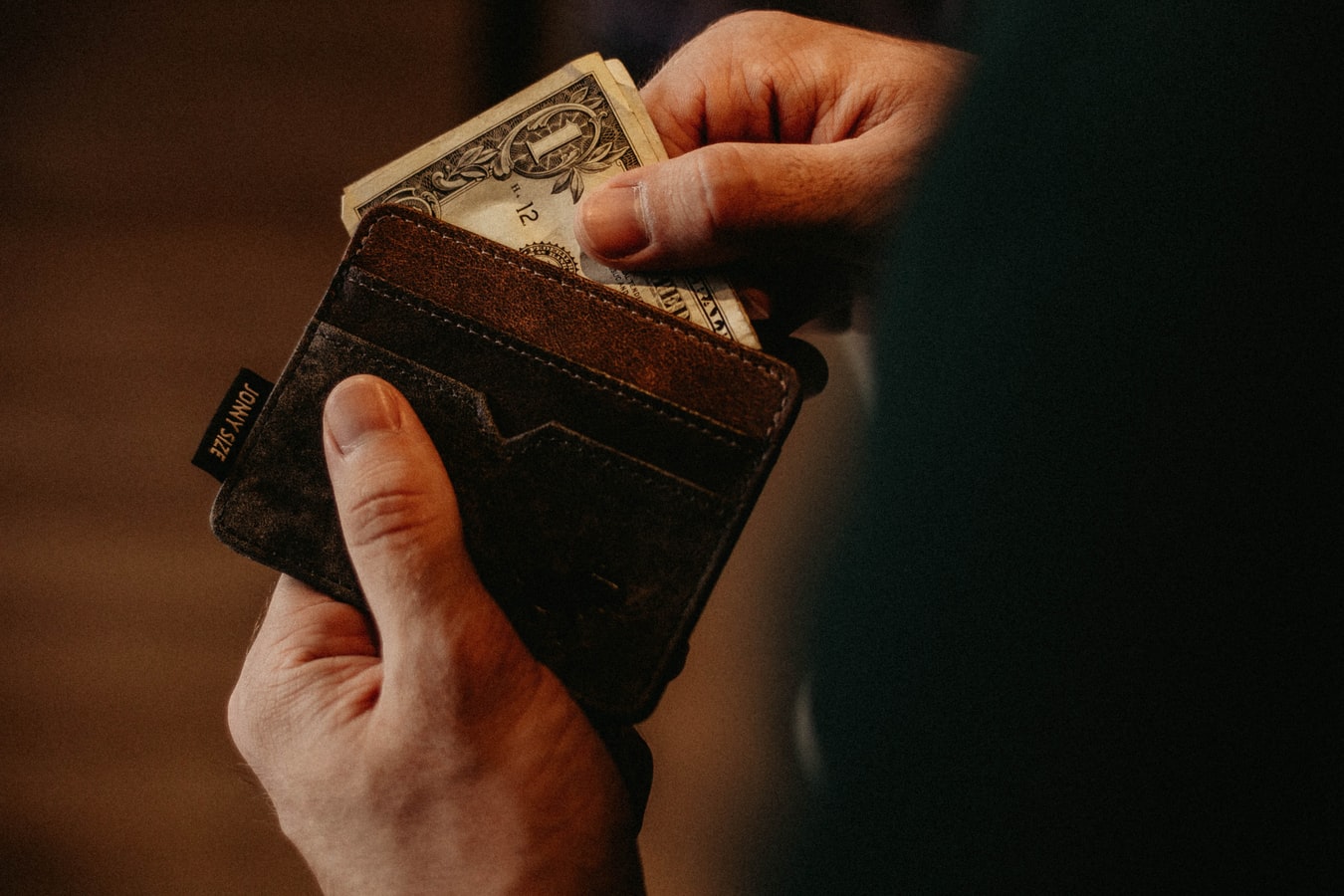 man-holding-wallet-with-money